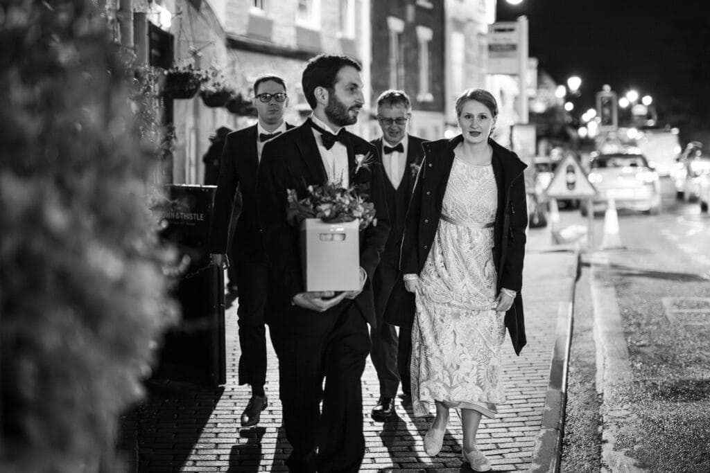 Bride walking down the high street to be married at the Crown and Thistle.