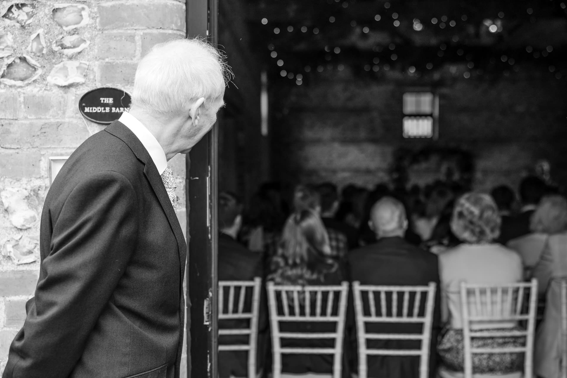 Father of the Bride looking into the wedding ceremony barn at the Gathering Barn