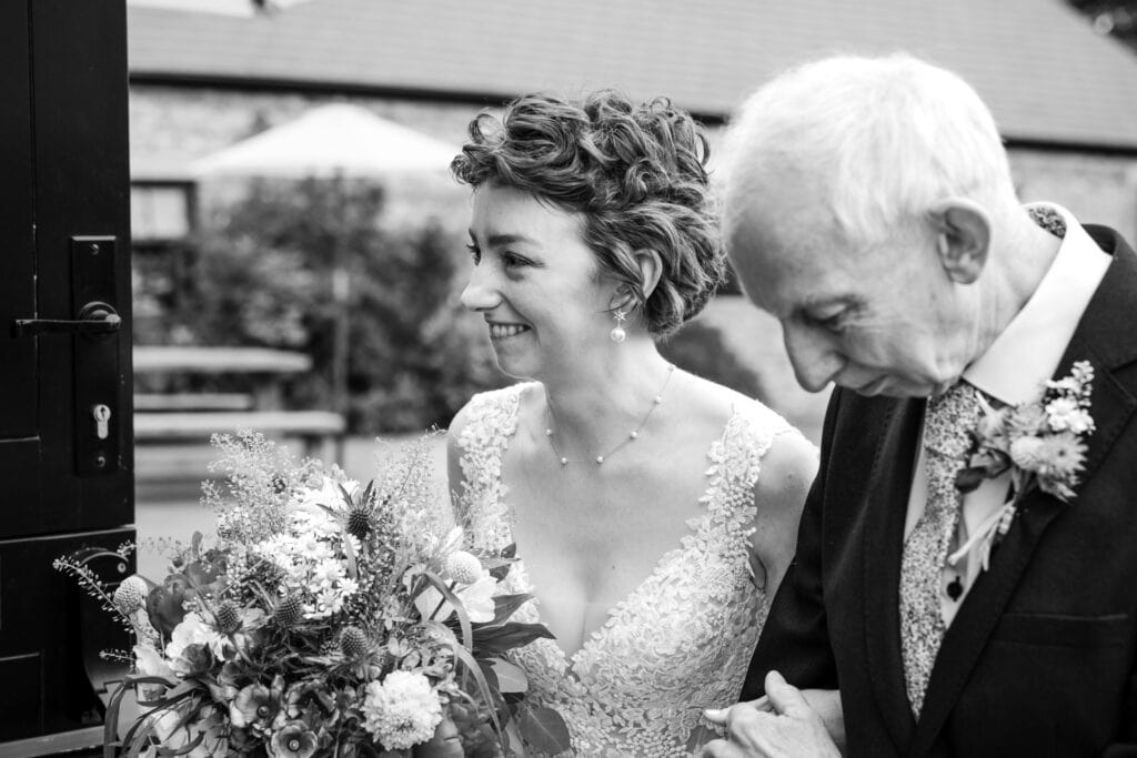 Father of the Bride and Bride as they are about to enter the Wedding Barn.