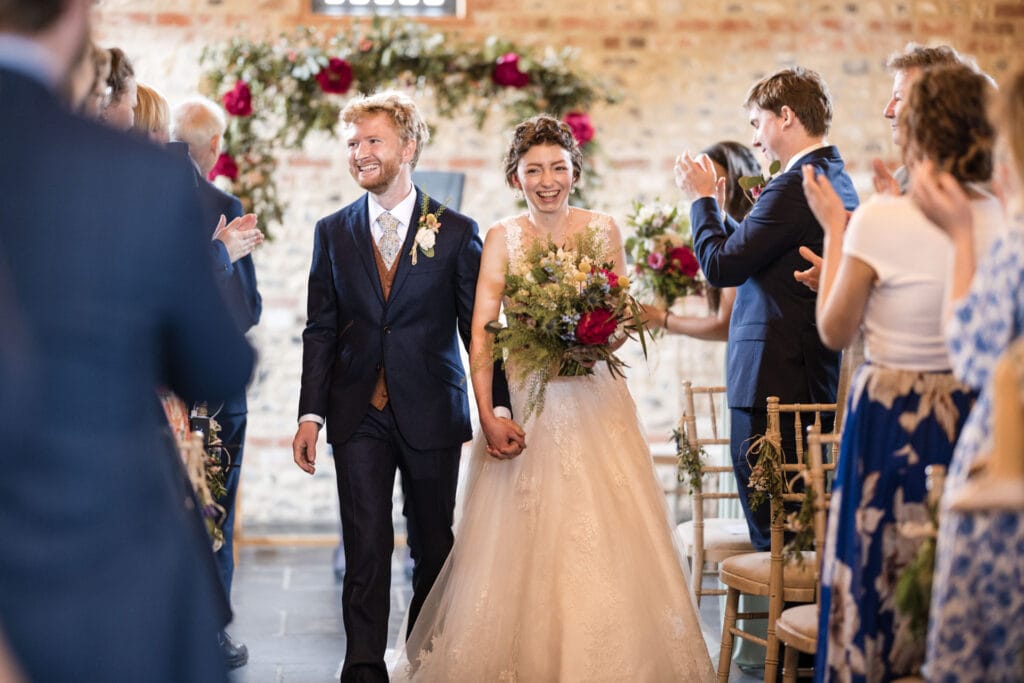 bride and groom walking down the aisle at the Gathering Barn