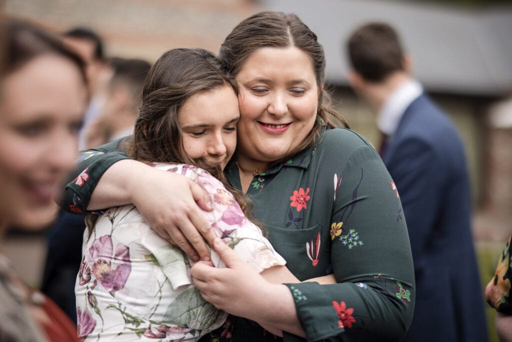 Two friends having a cuddle at the Gathering Barn