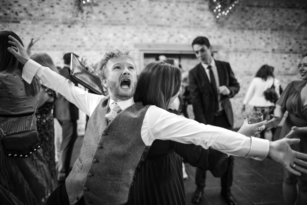 Groom having fun on the dance floor at the Gathering Barn