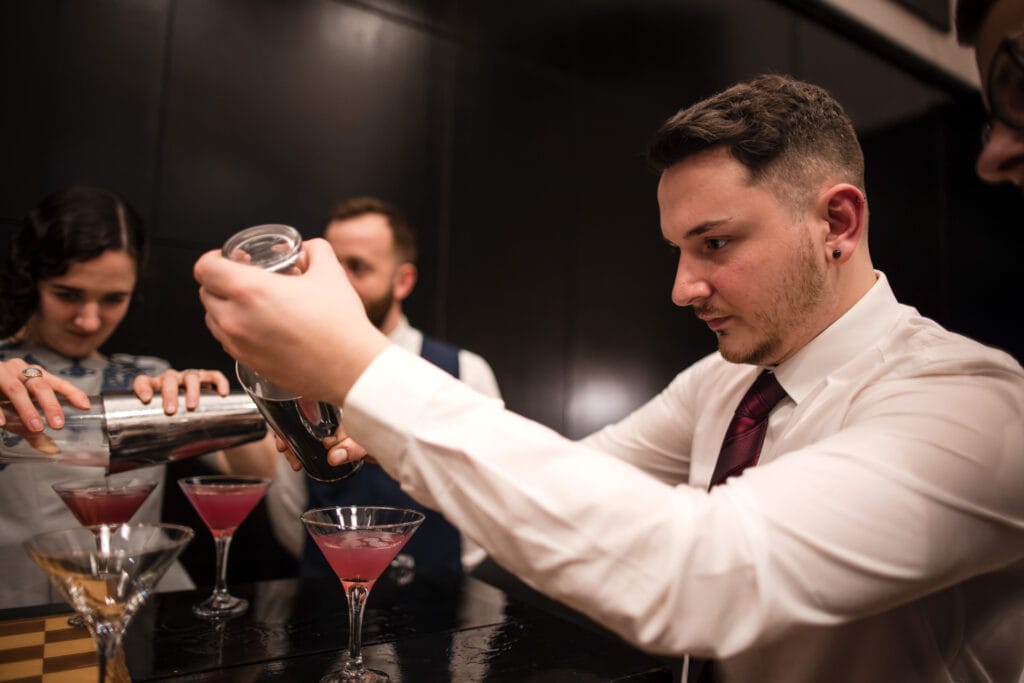 Guest with a cocktail shaker at the Malmaison Oxford
