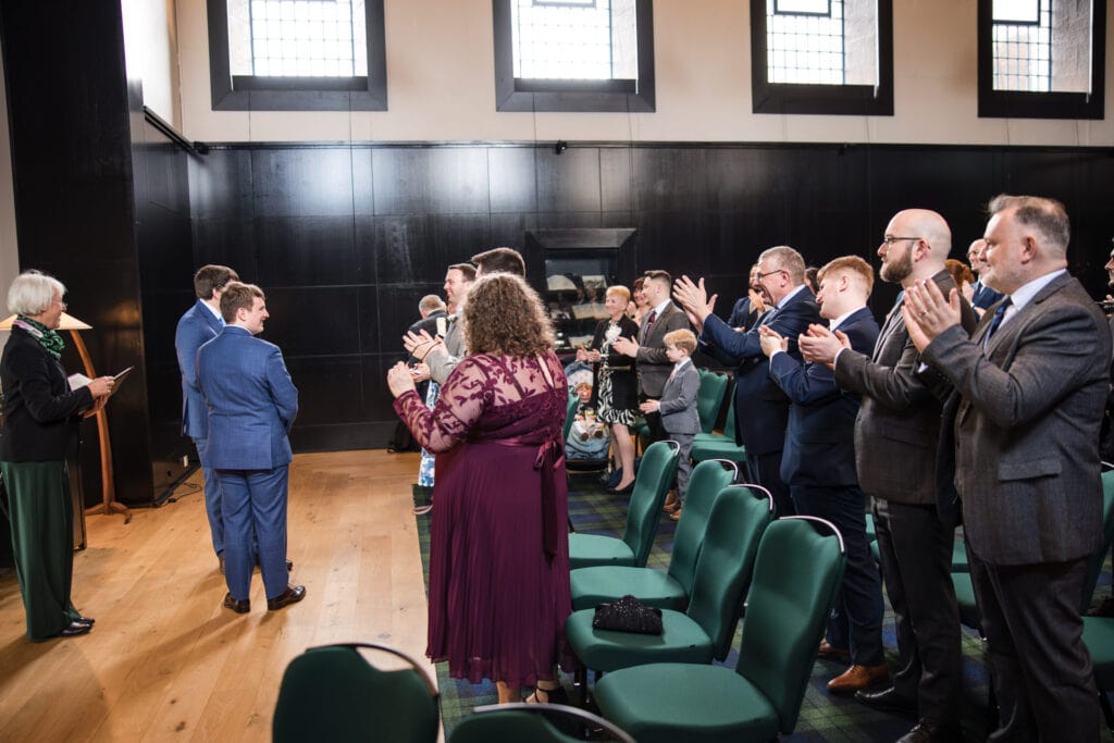 Guests congratulating the grooms on their marriage at the Malmaison Oxford