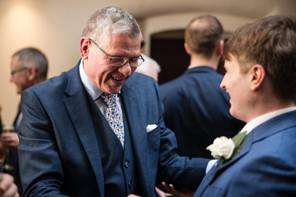Grooms friend congratulating him on his wedding day at Malmaison Oxford