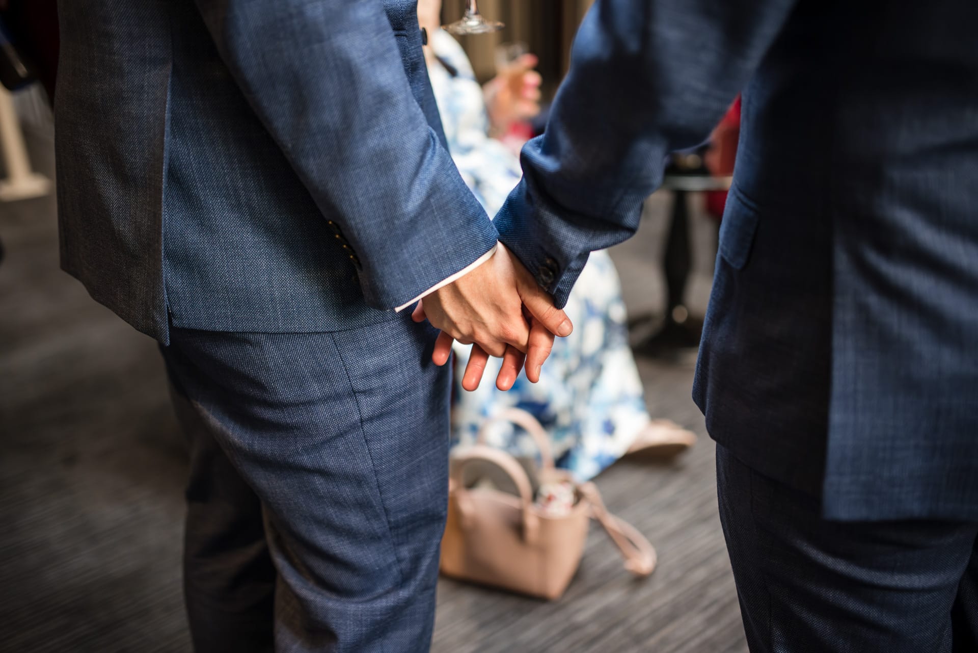 Grooms hold hands