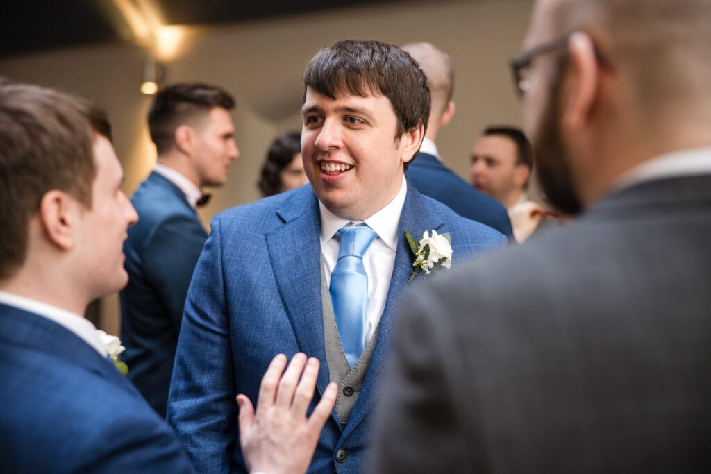 Grooms talking during drinks reception in the Malmaison Oxford