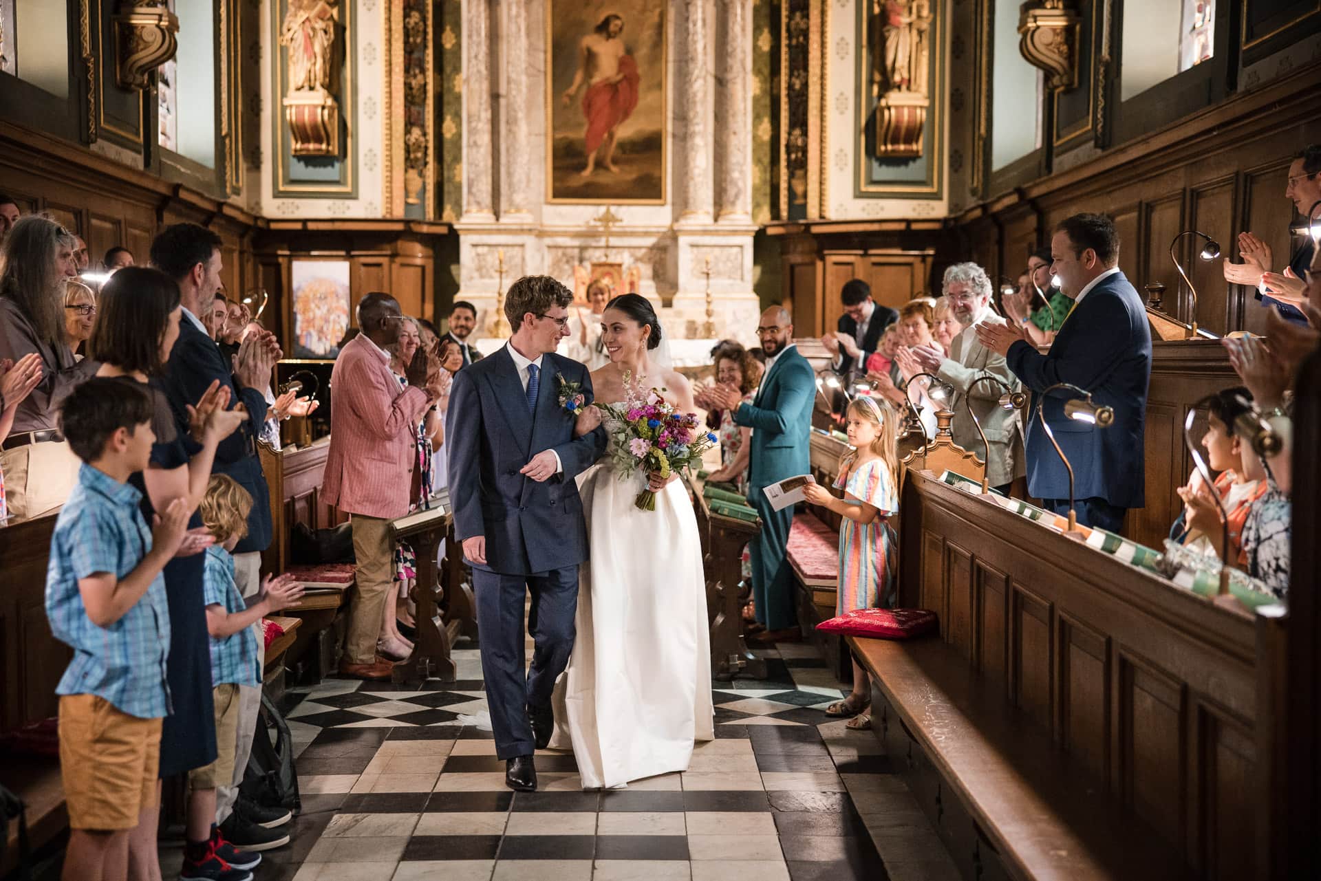 Bride and Groom walking down the aisle of the Damon Wells Chapel at Pembroke College Oxford
