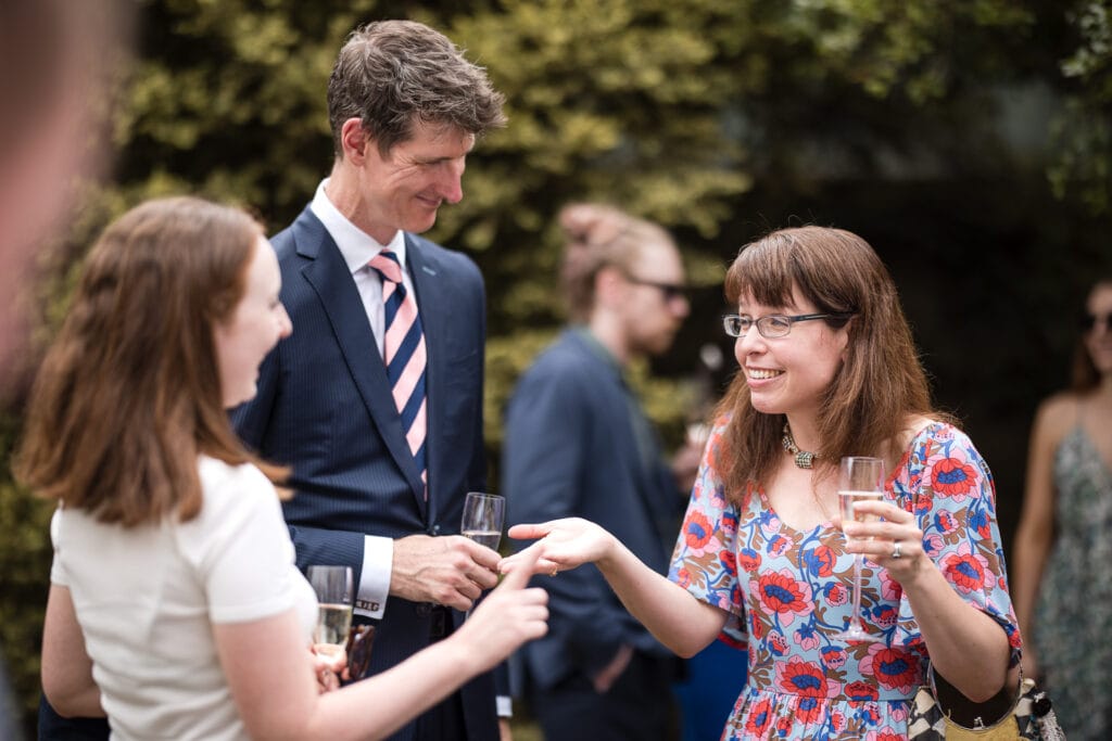 Guests talking in the Masters Garden at Pembroke College