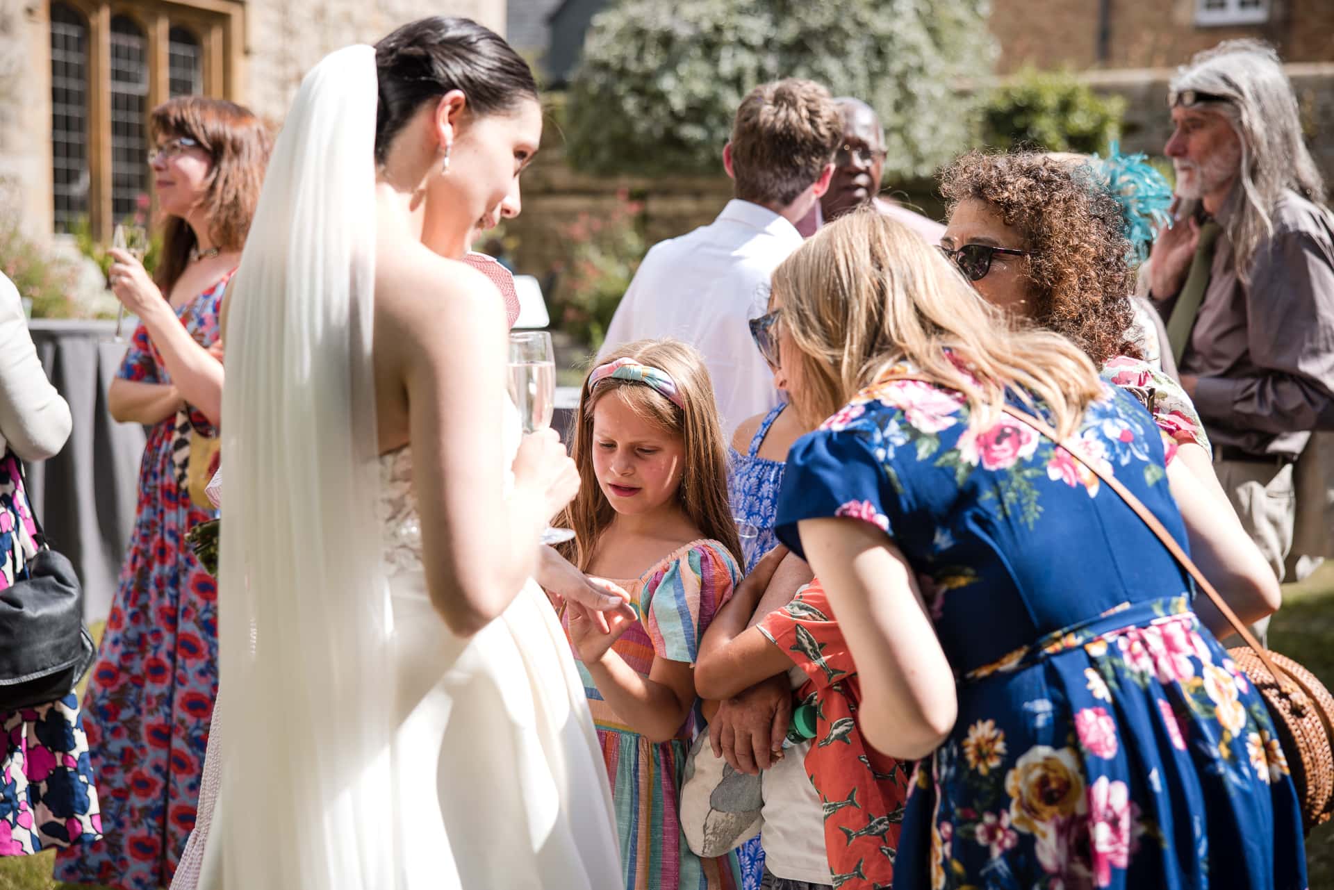 Guests admiring the Brides Wedding ring in the grounds of Pembroke College
