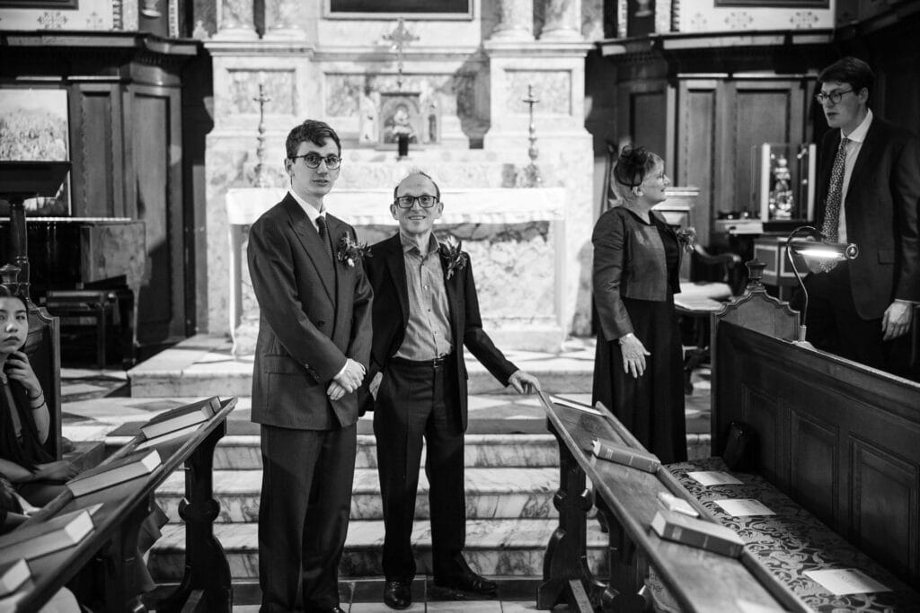 The Groom and Guest looking on inside the Damon Wells Chapel at Pembroke College