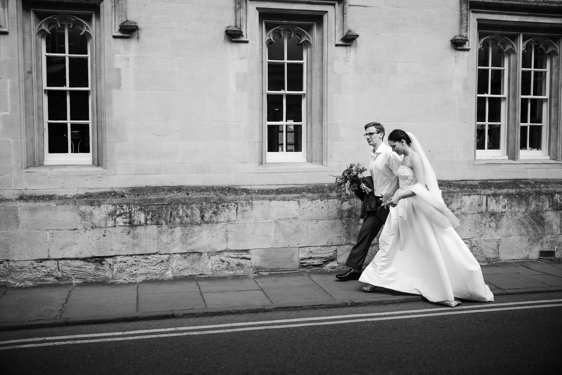 Bride and Groom walking down Catte street in Oxford