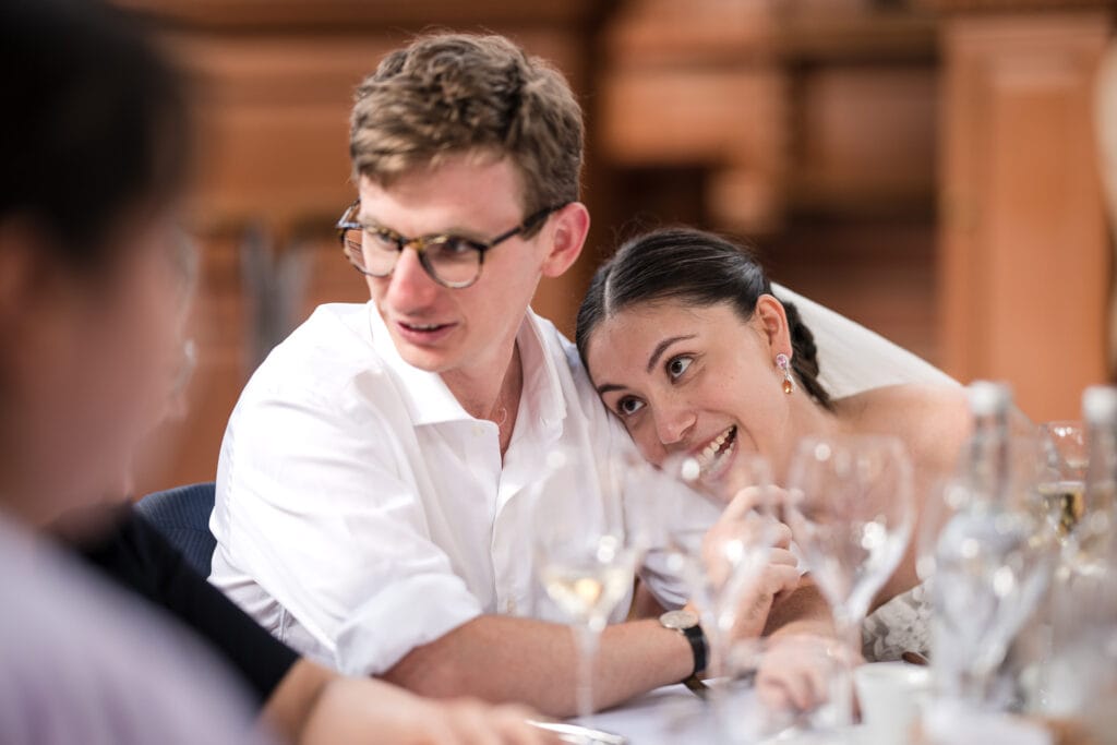 The bride leaning into the groom at the Sheldonian Theatre.