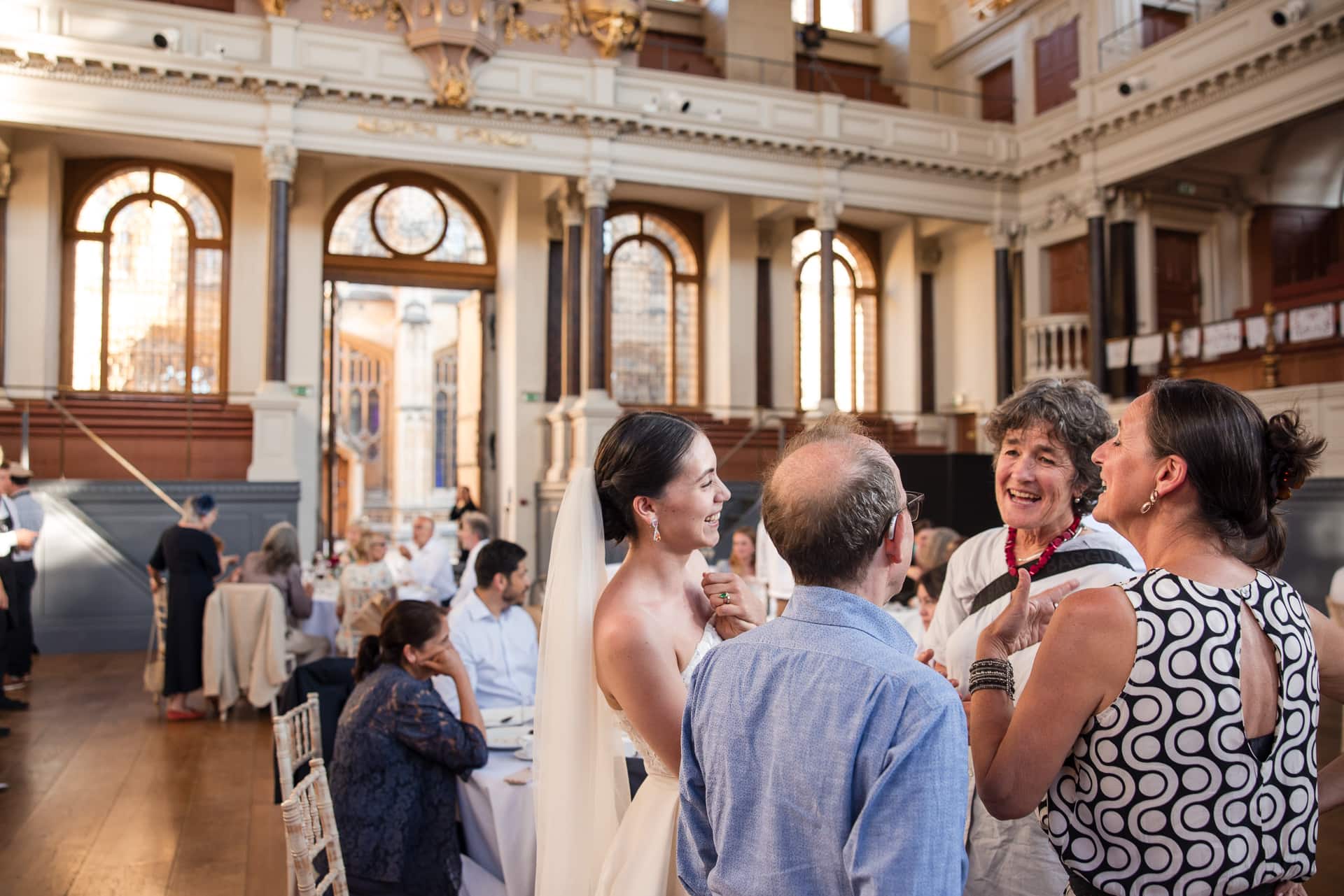 The bride talking with guests inside the Sheldonian Theatre Oxford