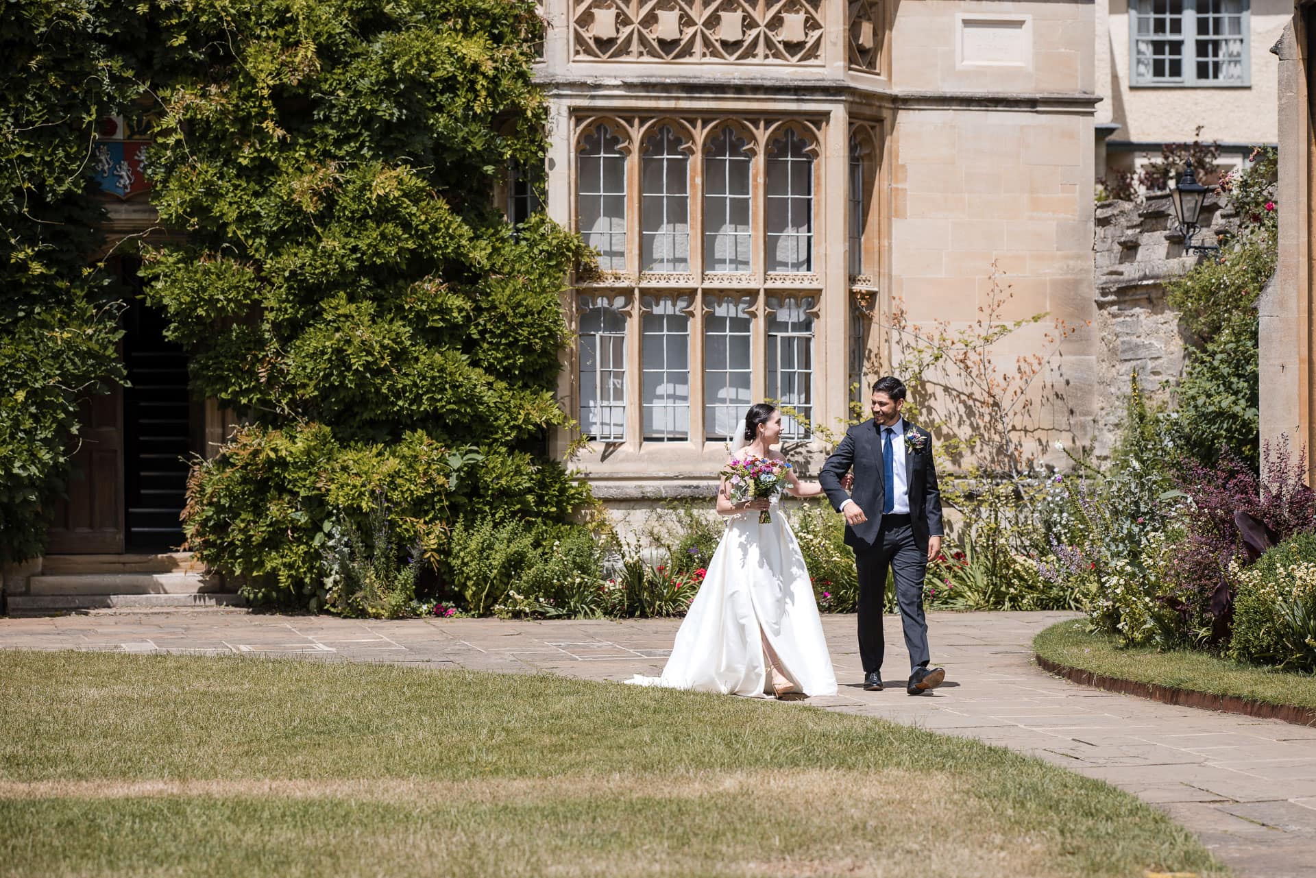 The Bride and her brother walking together in the grounds of Pembroke College.