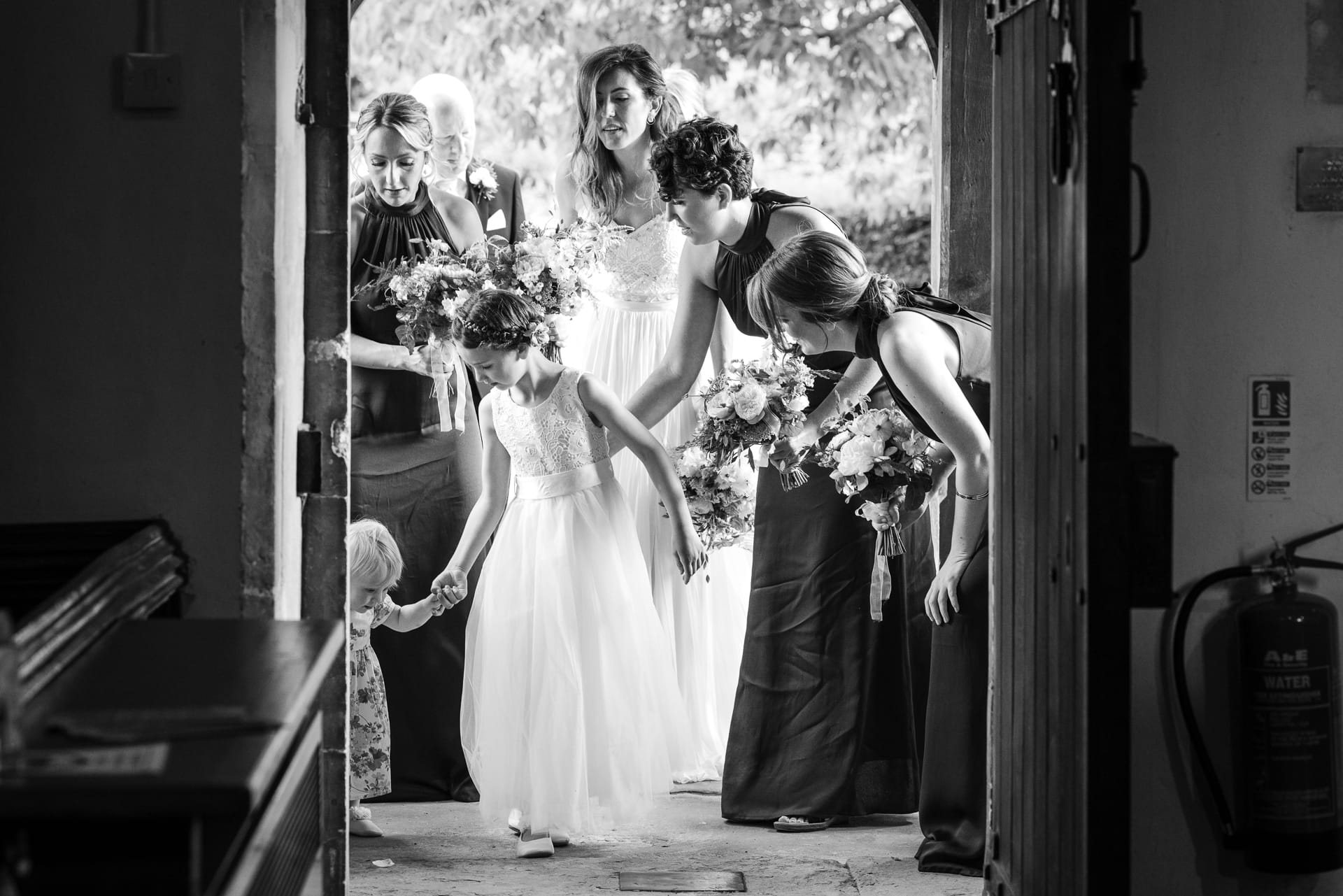 Bride and Bridesmaids entering the church at the Cotswold Sandhurst Wedding