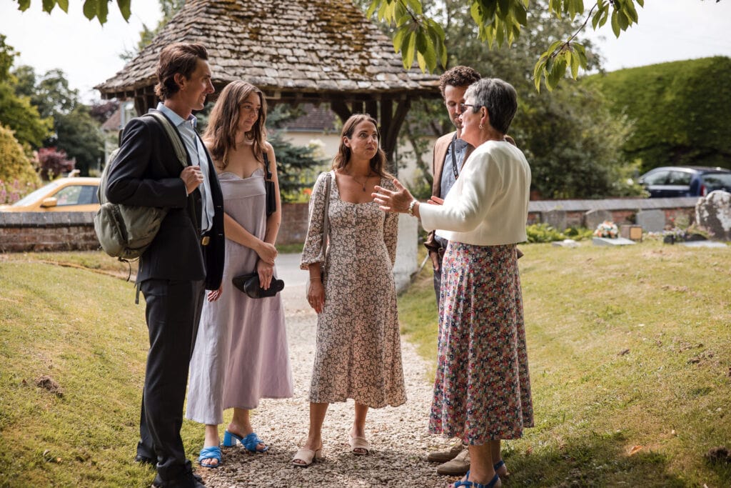 Guests talking on the path into the Church