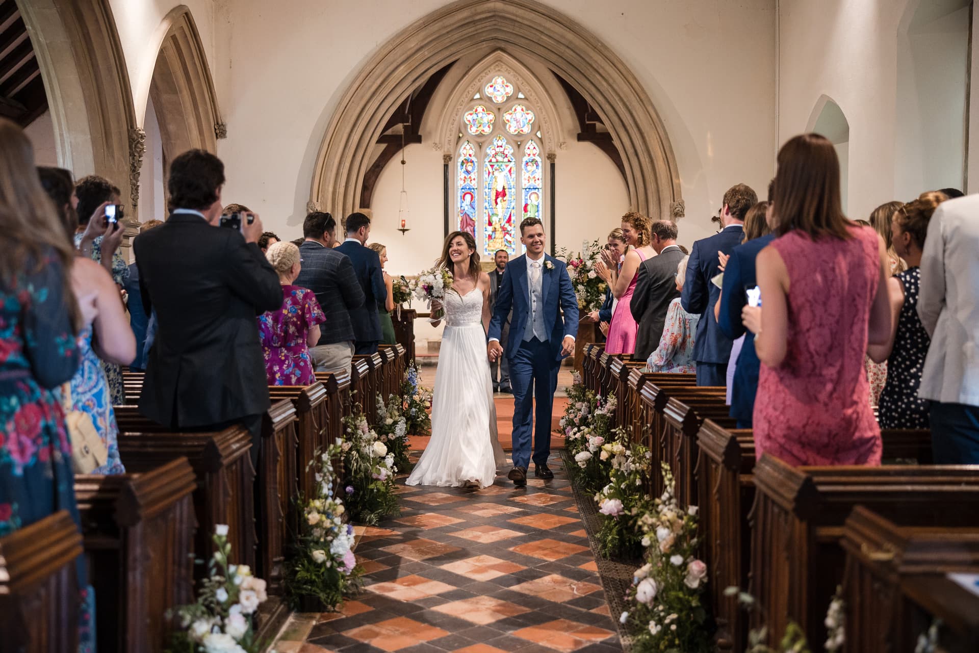 Bride and Groom walking down the aisle during Cotswold Sandhurst Wedding