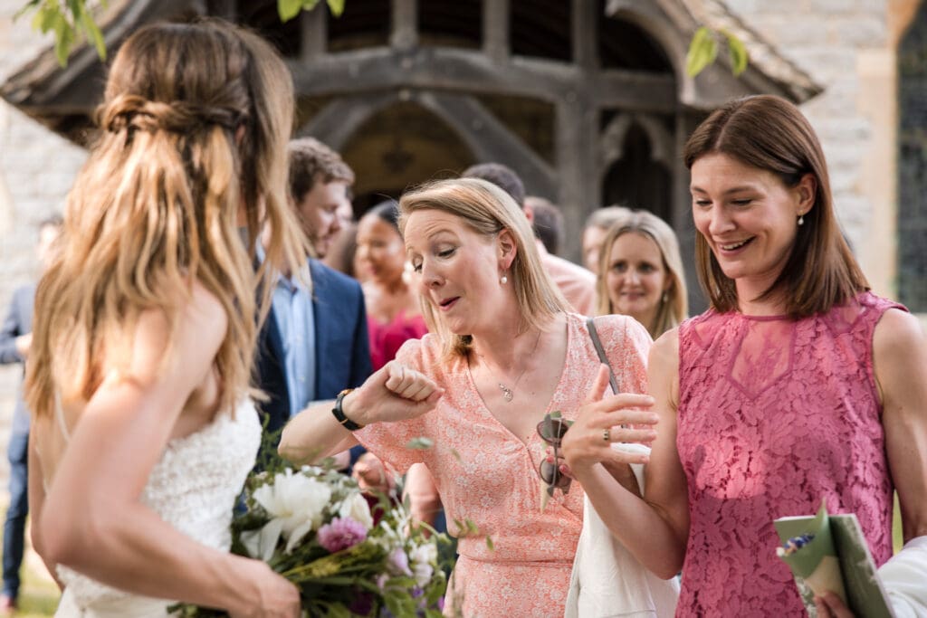Brides friend looking at her watch with the bride at the Sandhurst Wedding.