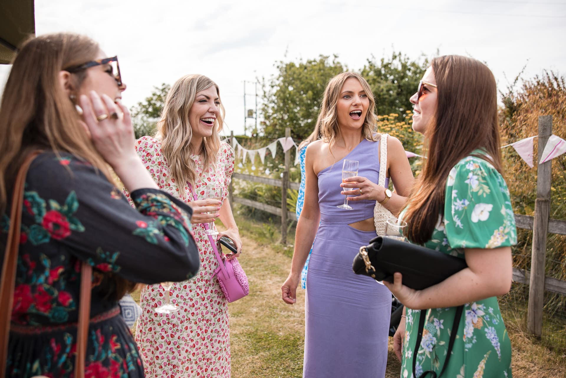 A group of ladies chatting and laughing at the Sandhurst Farm Wedding Reception