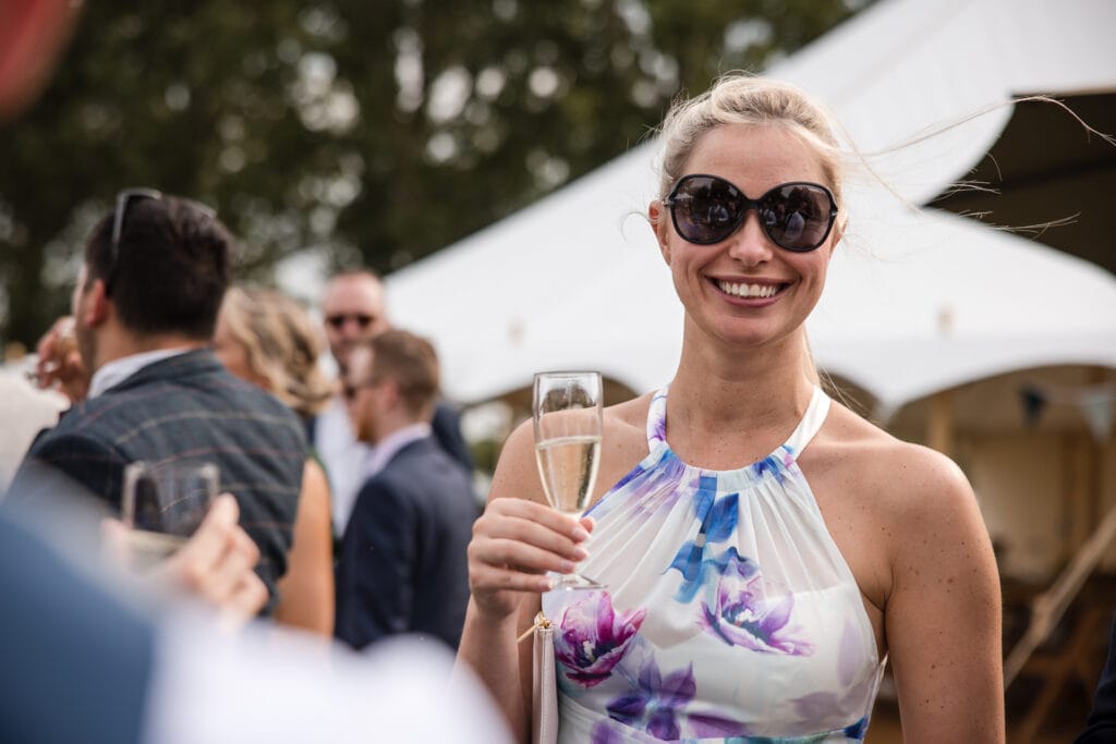 Happy guest drinking champagne at the Sandhurst Farm Wedding Reception