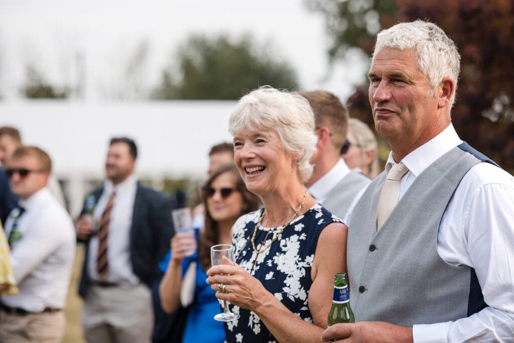 Father and mother of the groom look on at Sandhurst Farm Wedding Reception