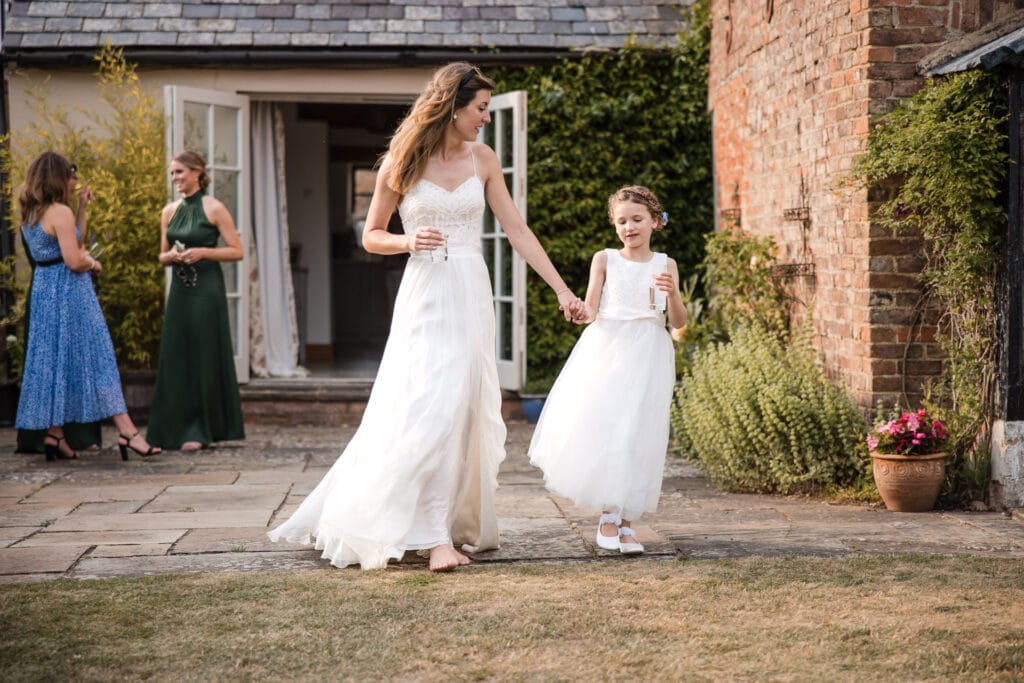 Bride and Pagegirl walking hand in hand