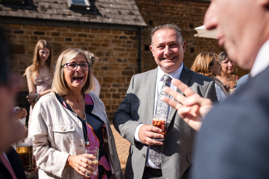Guests enjoying a catchup at a Dovecote Barn Wedding