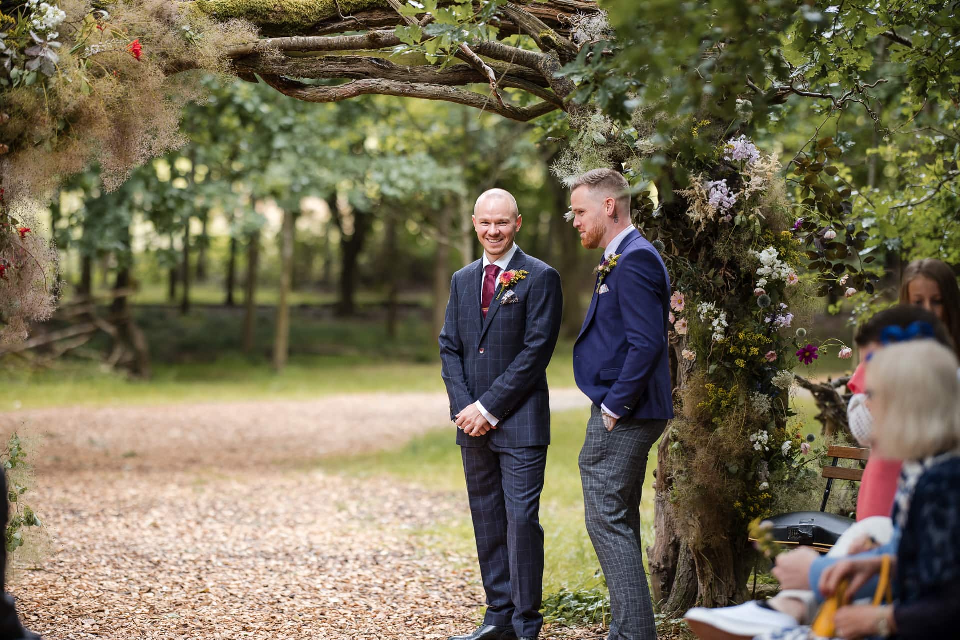 Groom and Best man chatting at the outdoor wedding ceremony