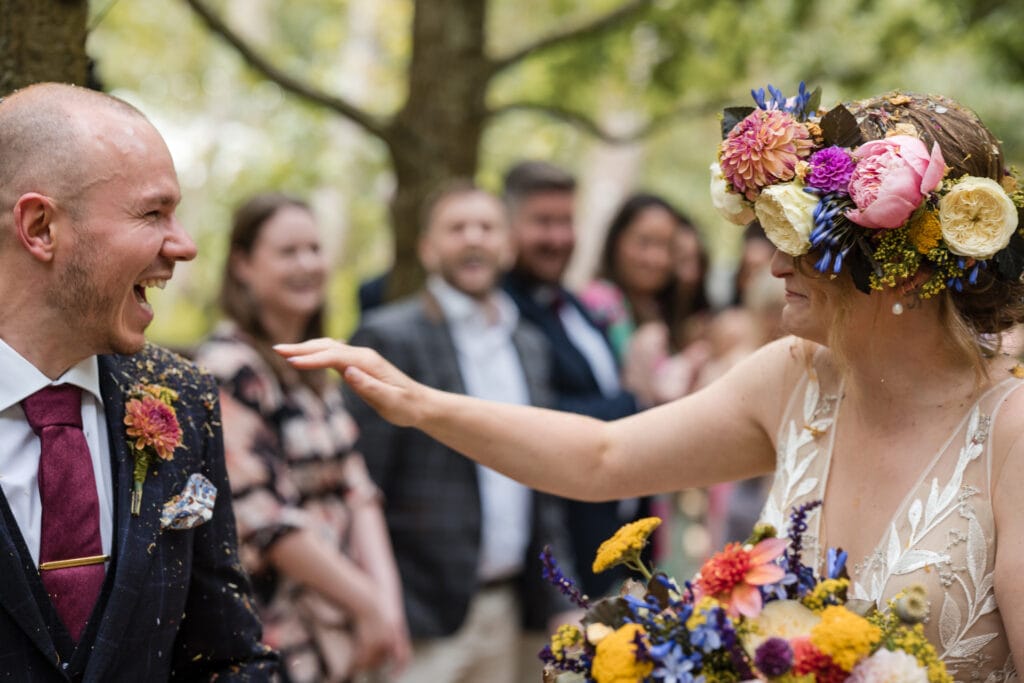 Bride and Groom laughing at the end of the confetti shot at the Endeavour Woodland wedding venue