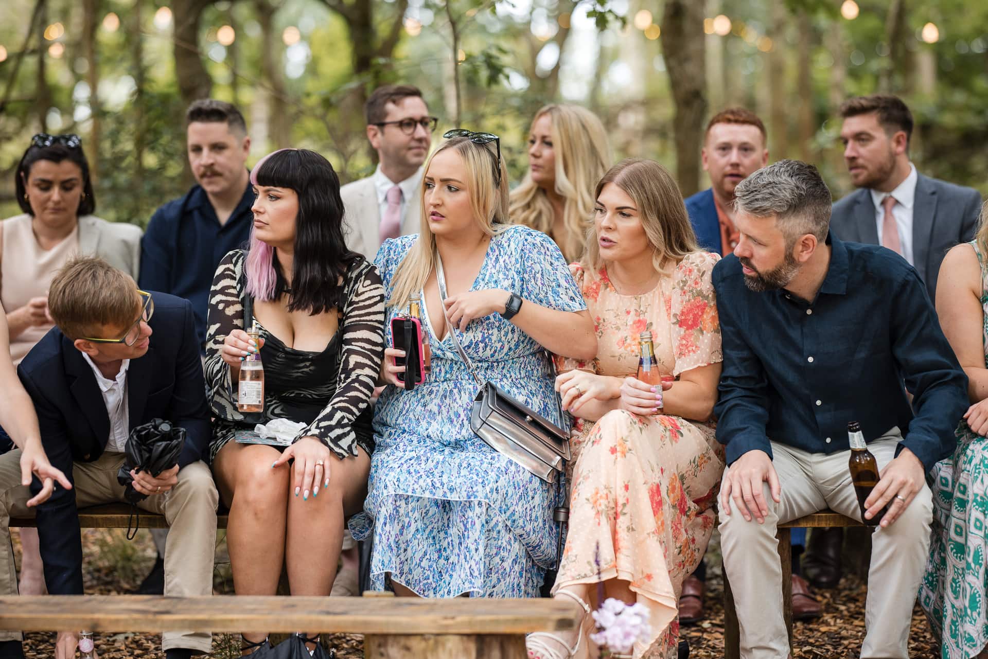 Guests chatting at the outdoor woodland wedding ceremony at Endeavour Woodland