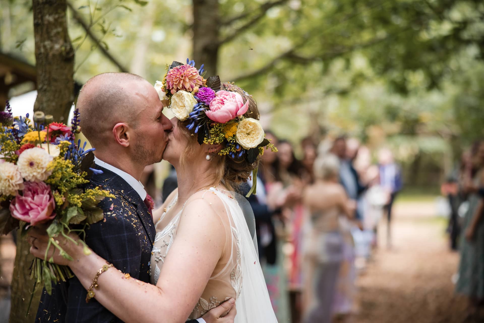 Bride and Groom kiss after confetti shot at Endeavour Woodland wedding venue