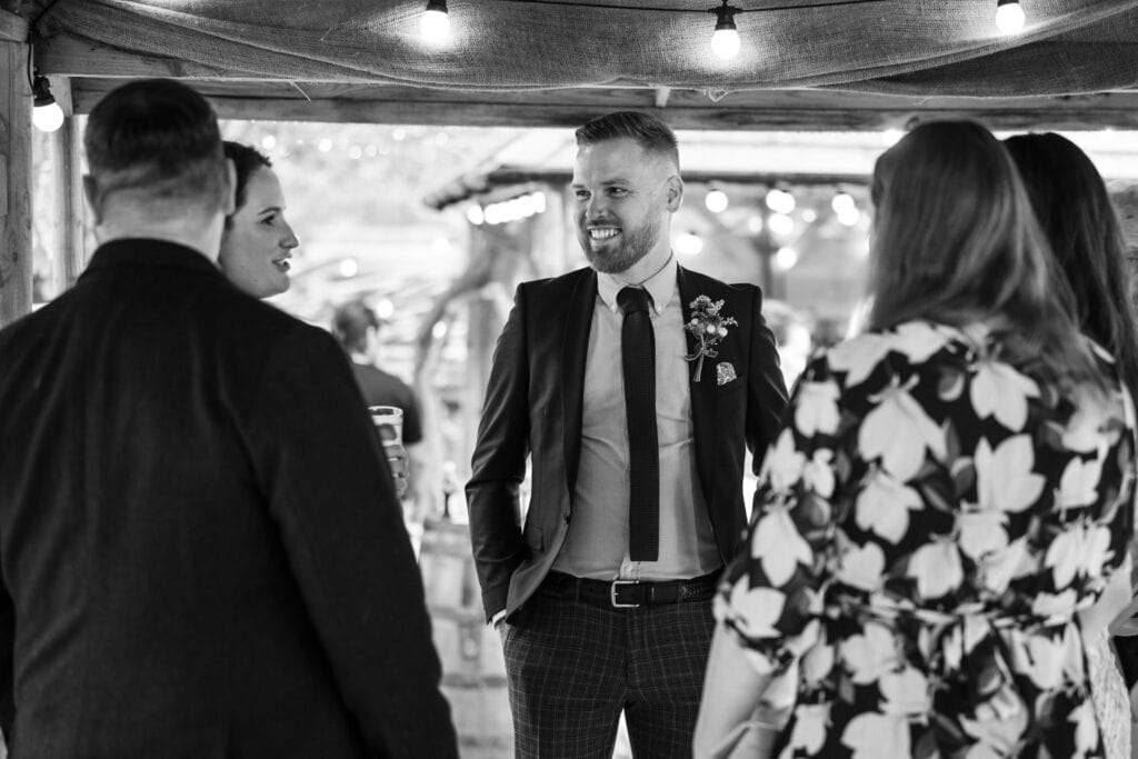 Best man talking to friends