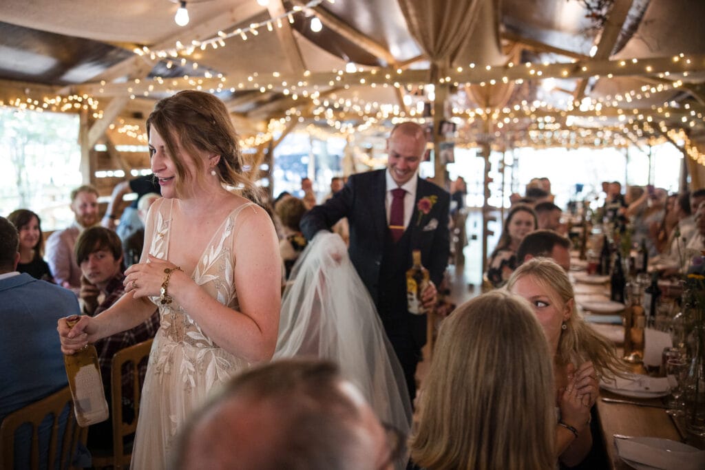Bride and Groom enter the barn for the wedding breakfast at the Endeavour Woodland wedding venue