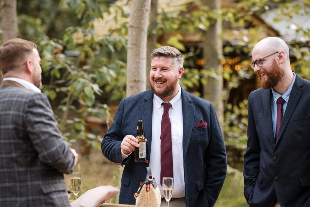 Guests enjoying a drink outside in the woodland at Endeavour Woodland wedding venue