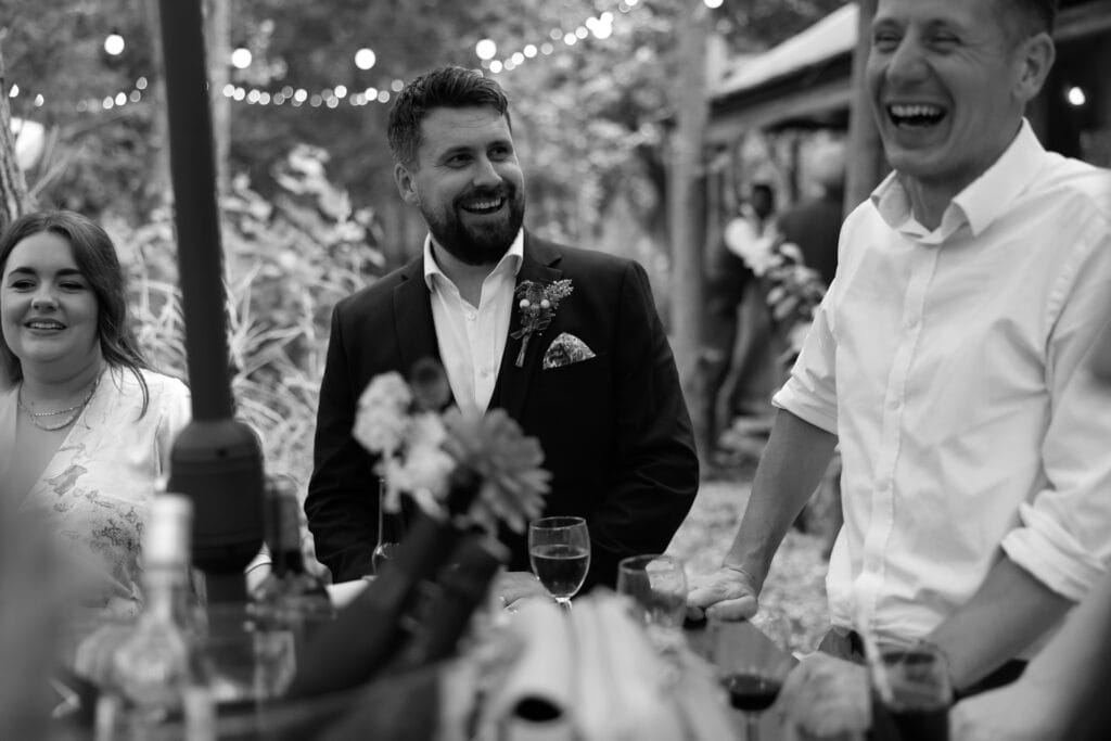 Guests drinking out in the woodland at the Endeavour Woodland wedding venue