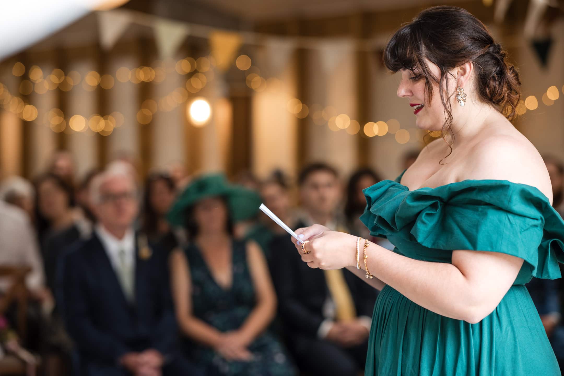 Bridesmaid talking to guests during ceremony at the Acorn Barn Wedding Venue