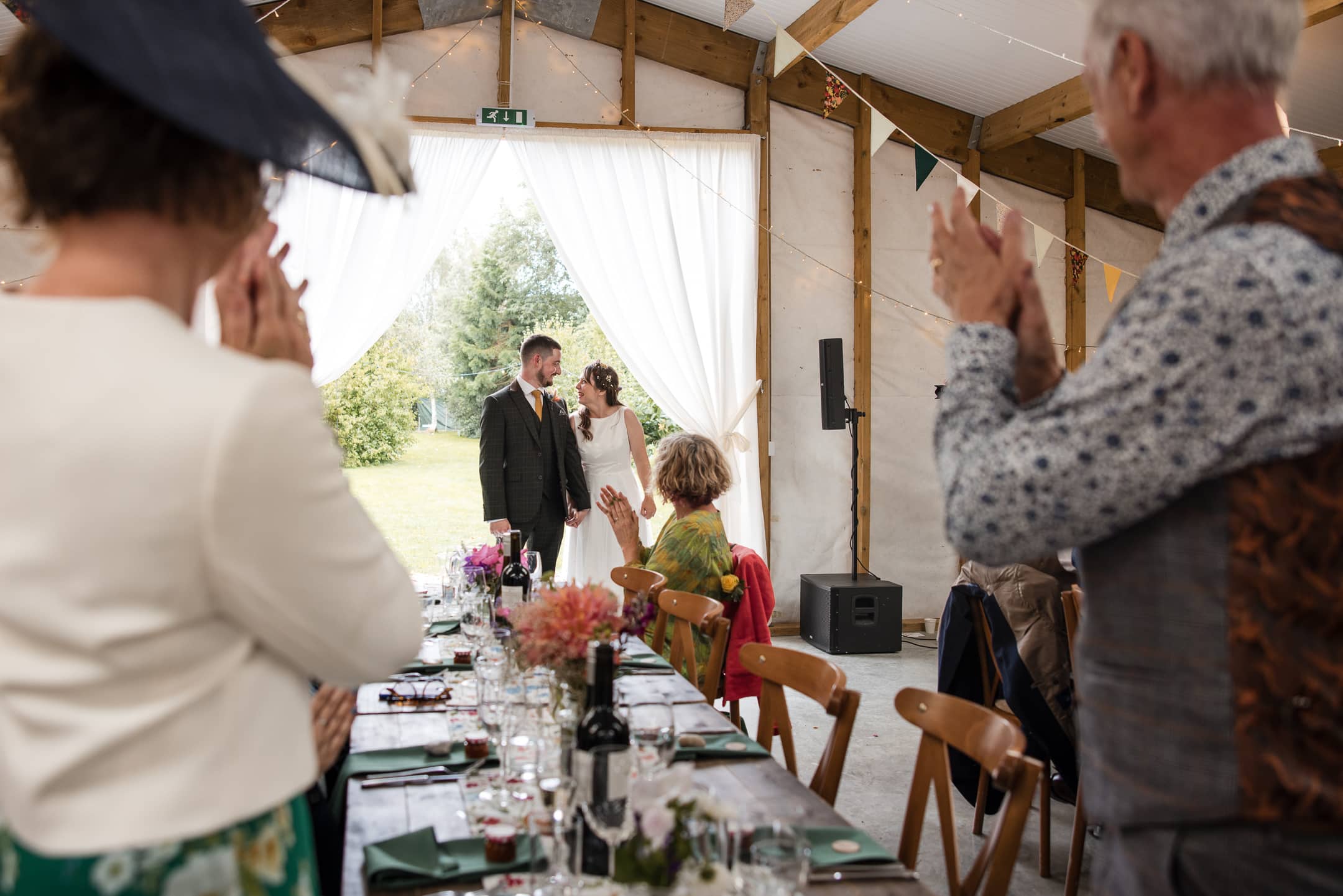 Couple enter the barn for wedding breakfast at the Acorn Barn Wedding