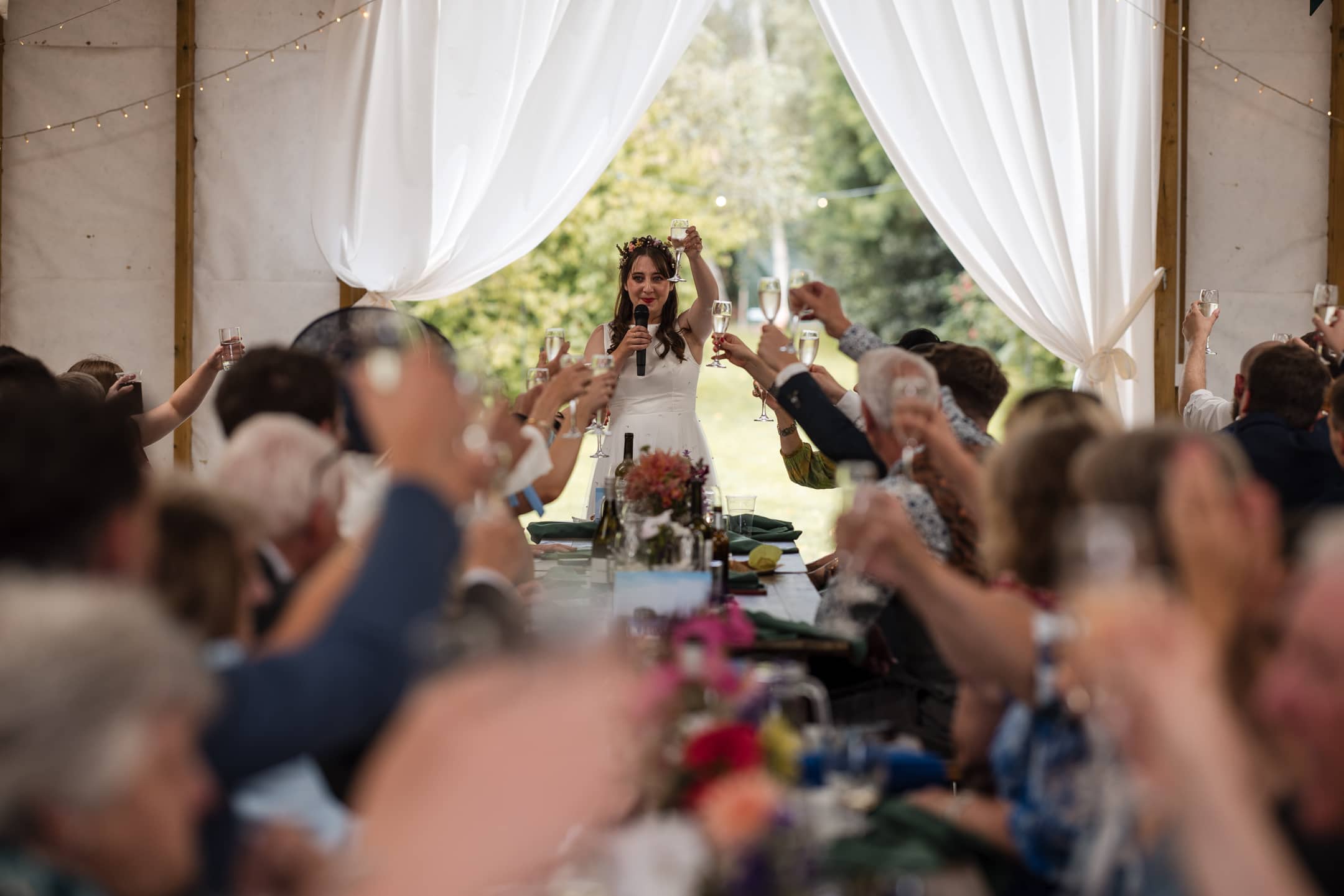 Bride raising glass during speech