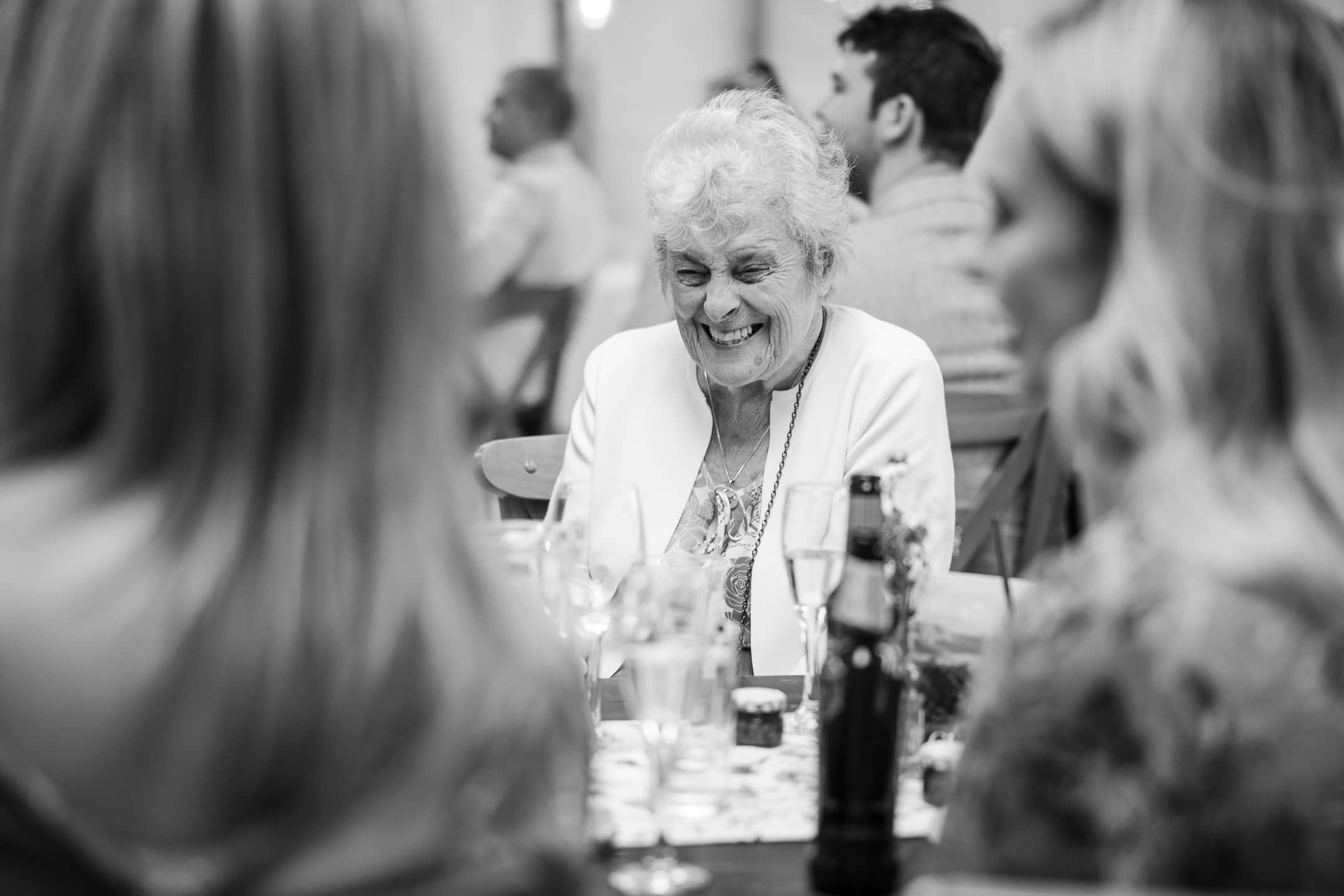 Old lady enjoying the speeches at the Acorn Barn Wedding Venue