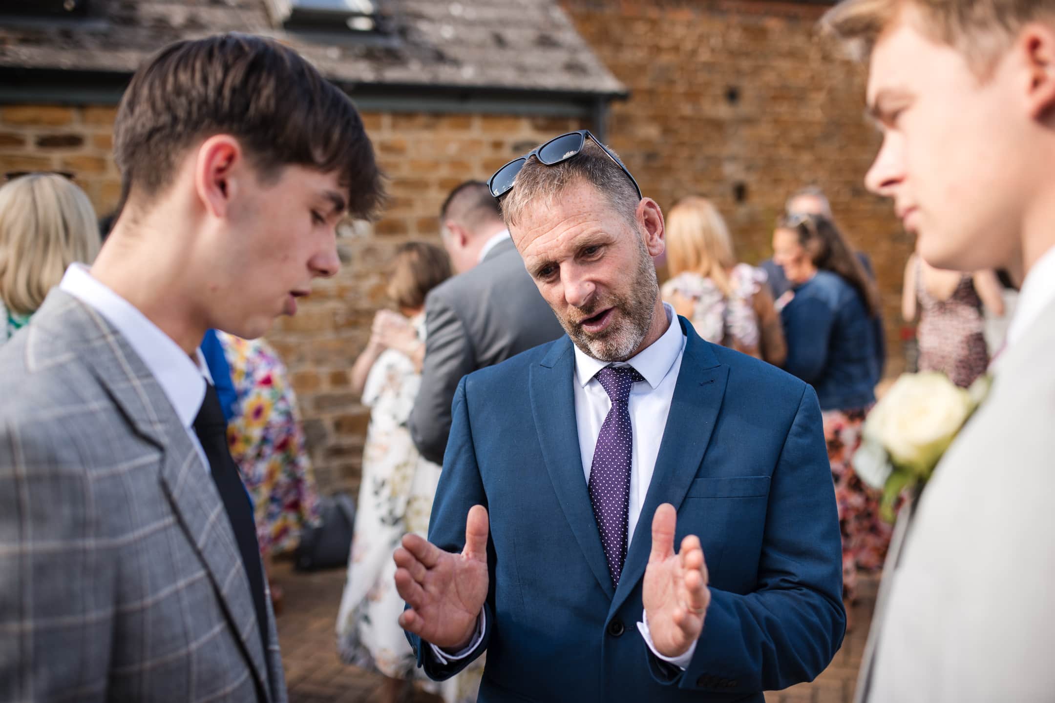 Guest stipulating the size of something whilst in conversation at the Dovecote Barn Wedding