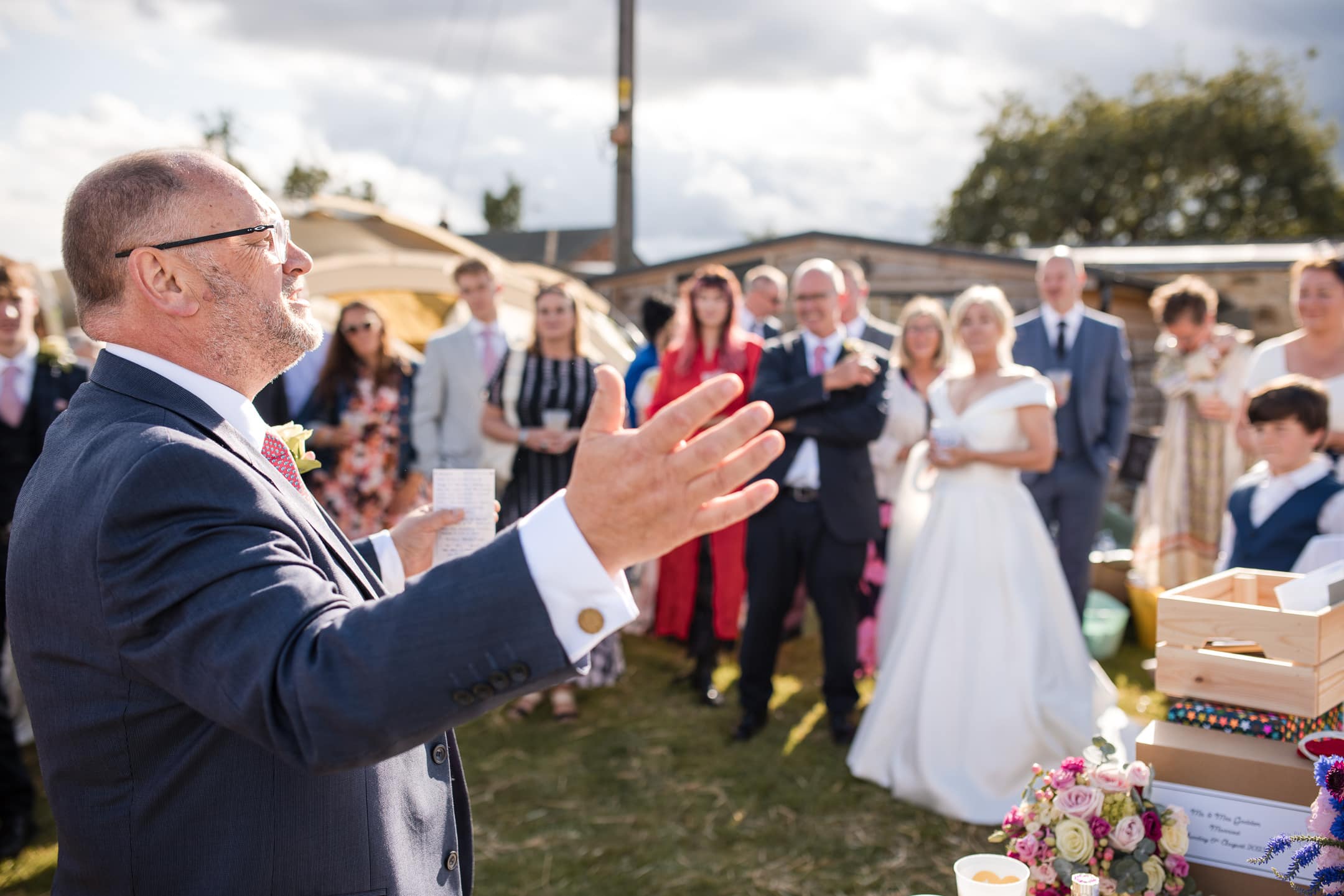 Best man doing his speech with guests in the background