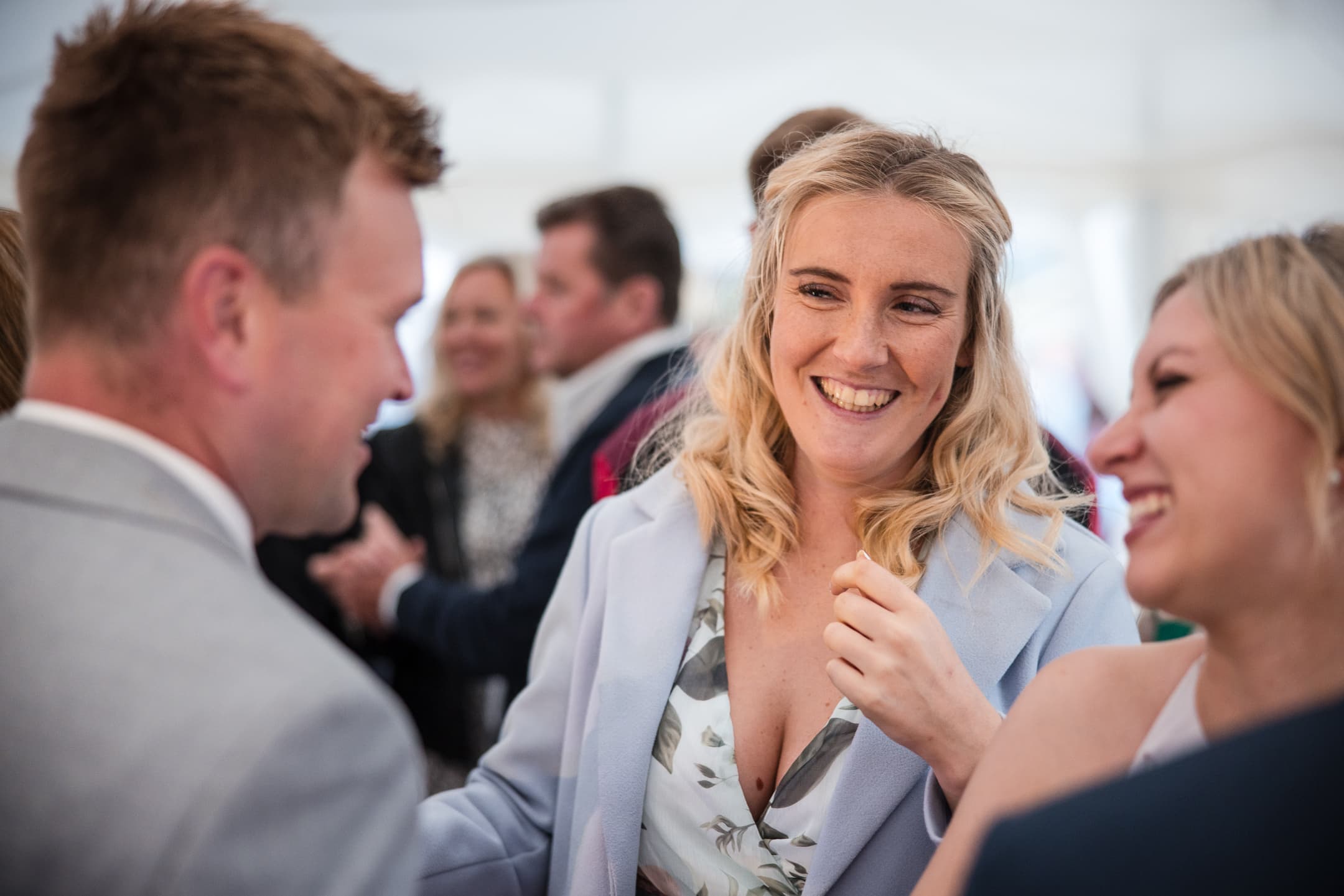 Guests talking and laughing in the Wedding Marque after the Dovecote Barn Wedding