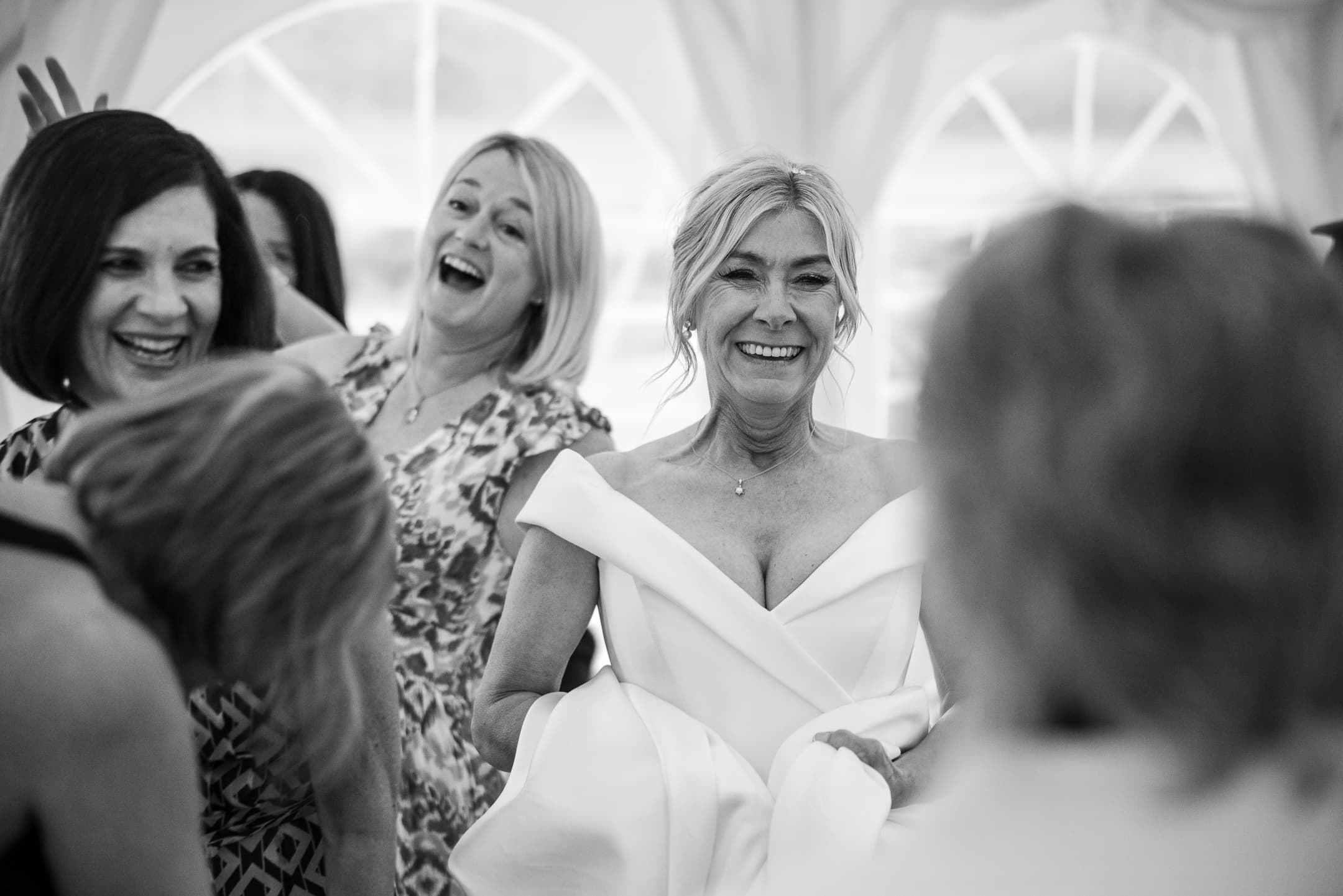 Bride laughing with friends at the wedding