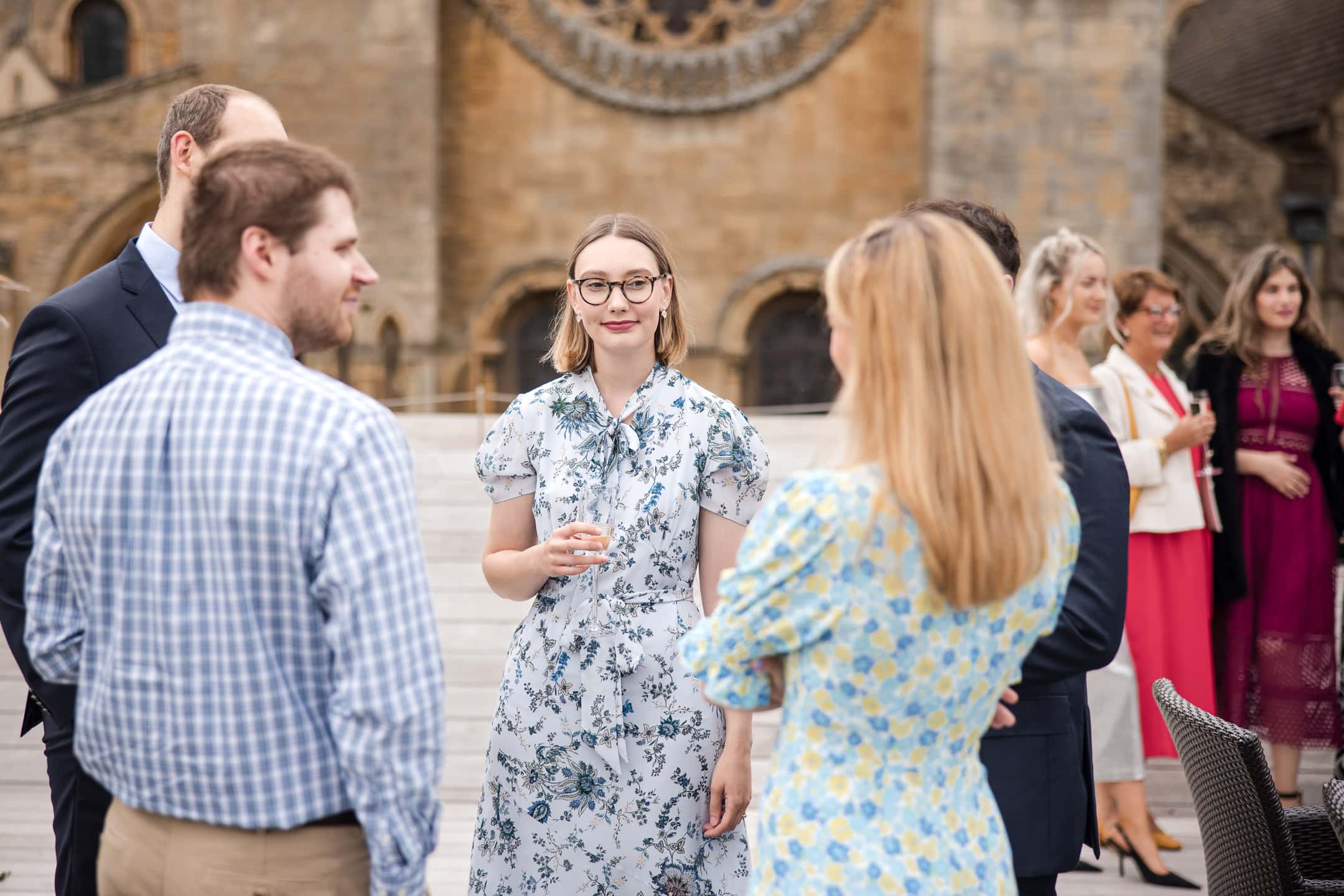 Guests chatting and drinking champagne during Corpus Christi College Oxford Wedding