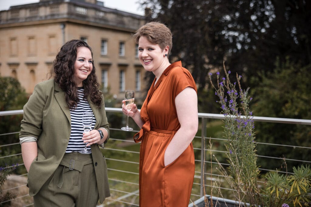 Couple drinking champagne on the roof terrace at Corpus Christi College Oxford