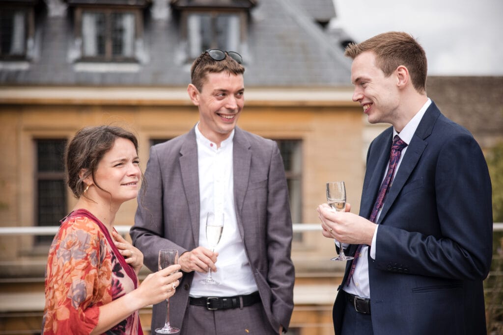 Groom talking to guests on the Corpus Christi terrace
