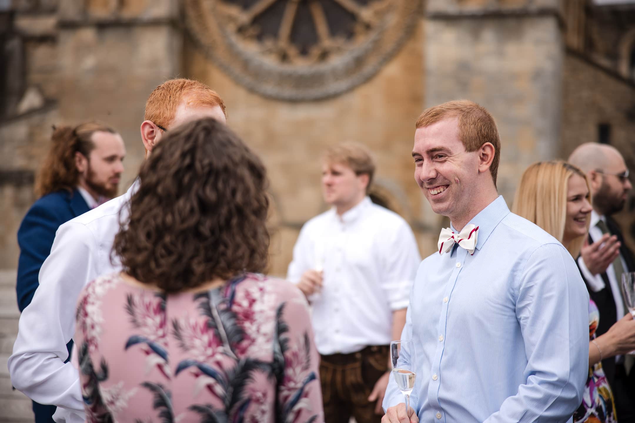 Friends talking on the terrace at Corpus Christi College Oxford
