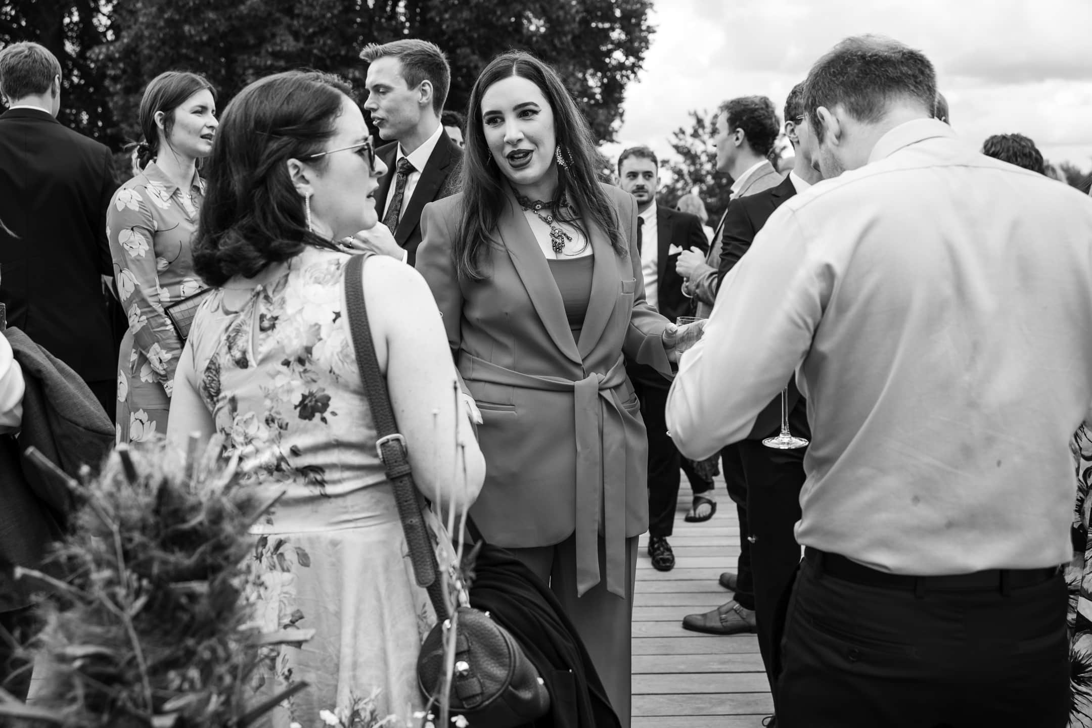 Bride catching up with guests on the terrace at Corpus Christi College Oxford