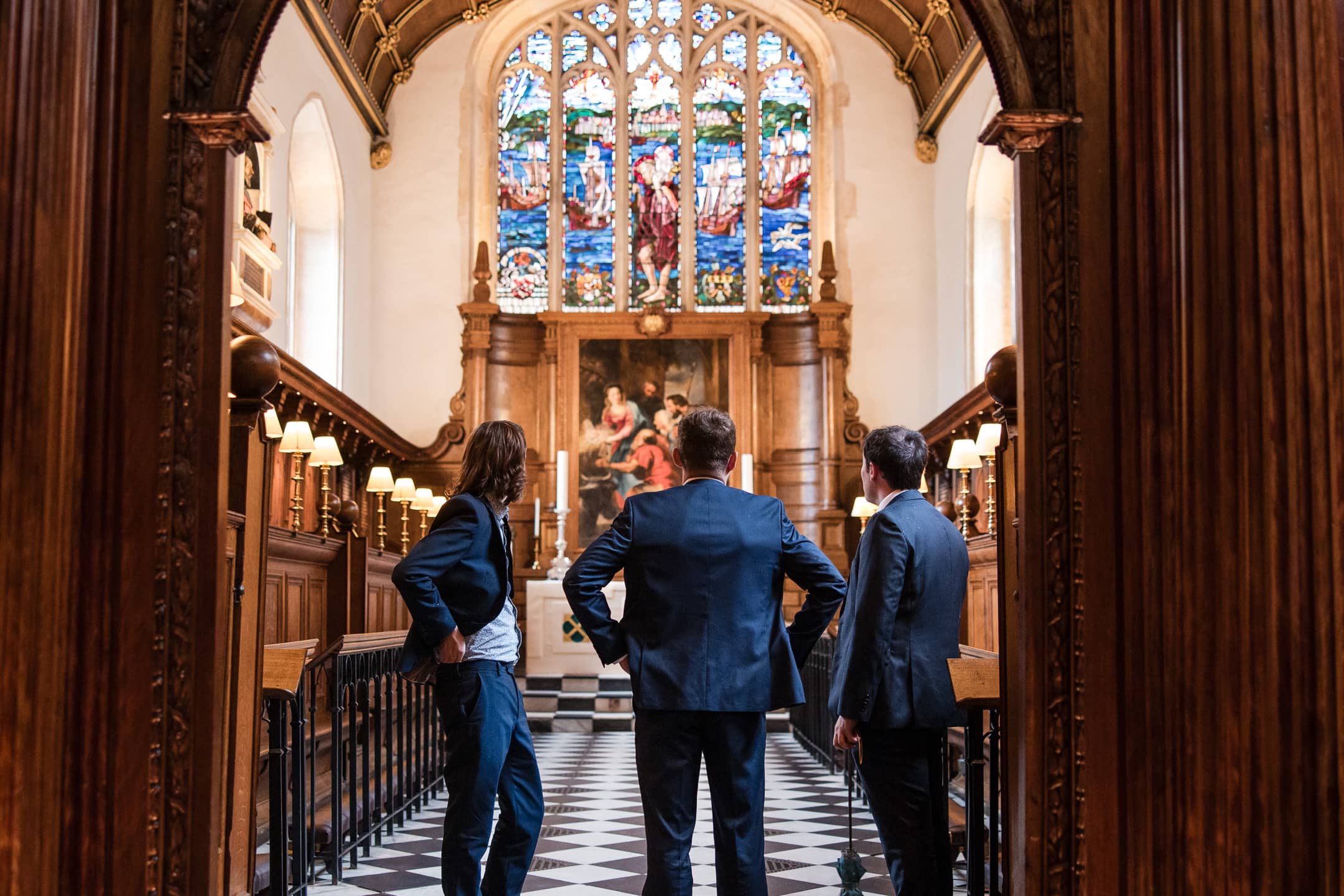Wedding guests admiring the chapel at Corpus Christi College Oxford